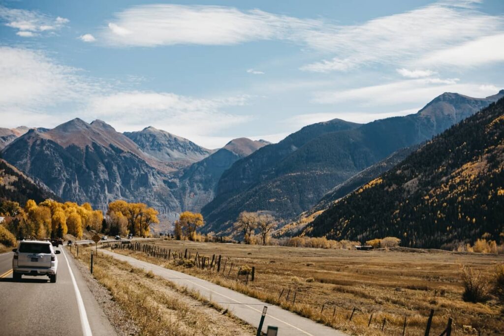 a photo of car on mountain highway in Colorado out for a day trip