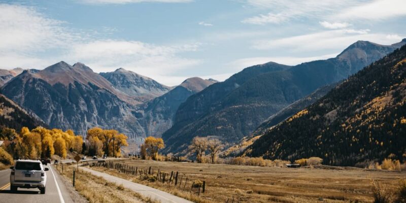 a photo of car on mountain highway in Colorado out for a day trip