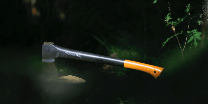 photo of a Fiskars hatchet stuck in a tree stump