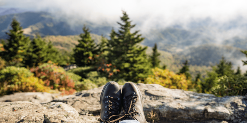 a photo of hiking boots with the laces visible taking a break on the trail