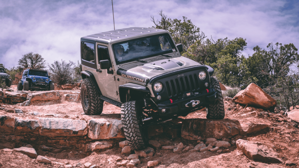 overlanding with a jeep. A jeep driving over some rocks