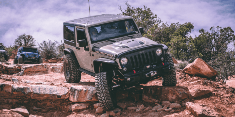 overlanding with a jeep. A jeep driving over some rocks