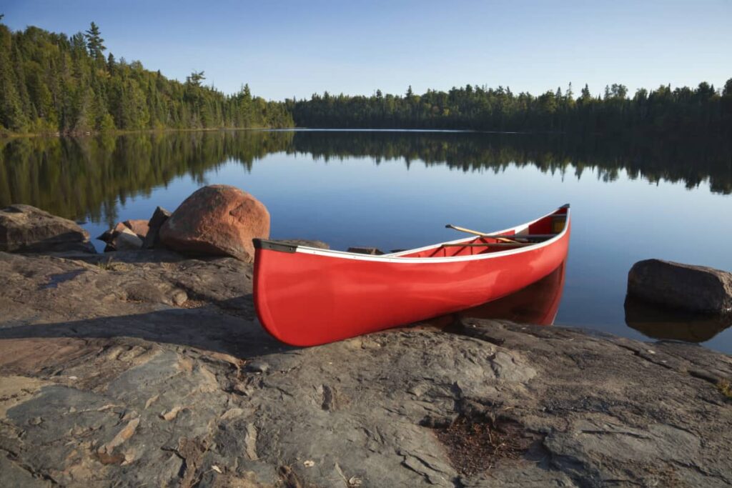 a red canoe on a mountain lake