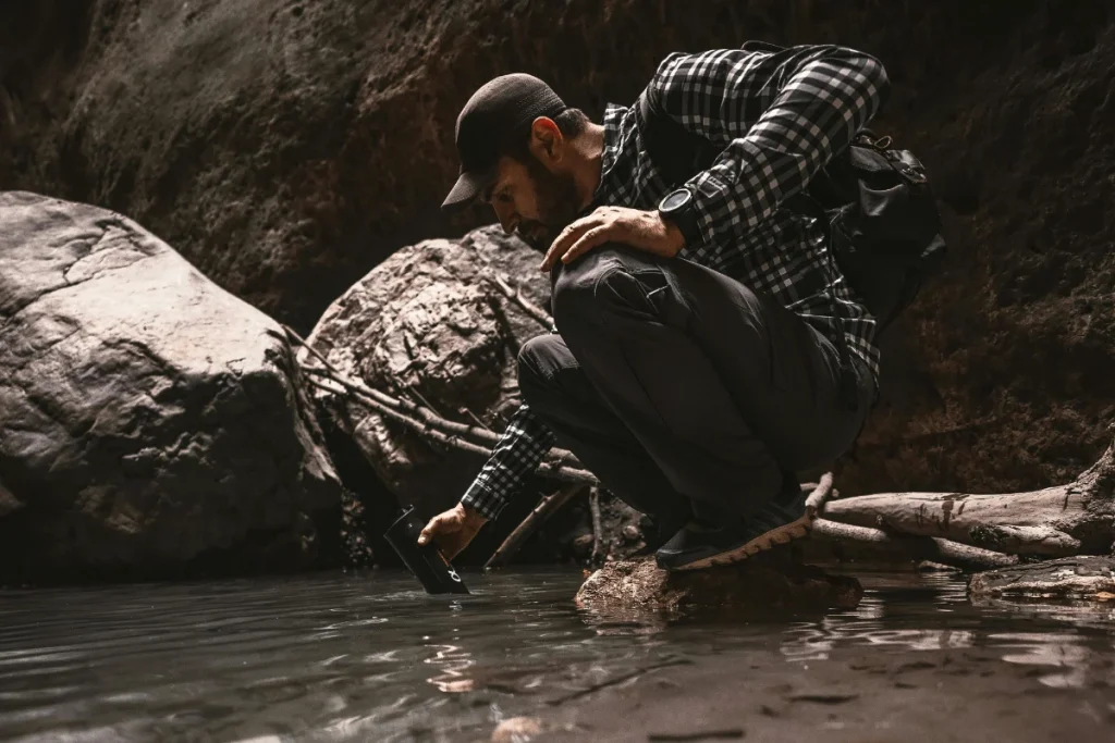 a guy filling a water purification device
