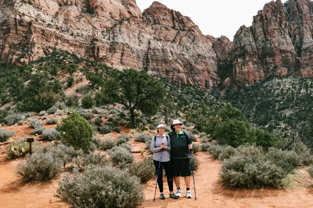 hiking for beginners. a couple hiking in Zion National Park showing proper hiking gear