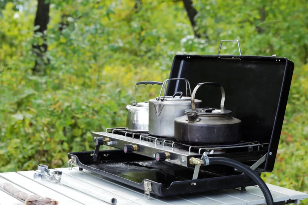 Camp cooking - a propane portable stove with pots and pans