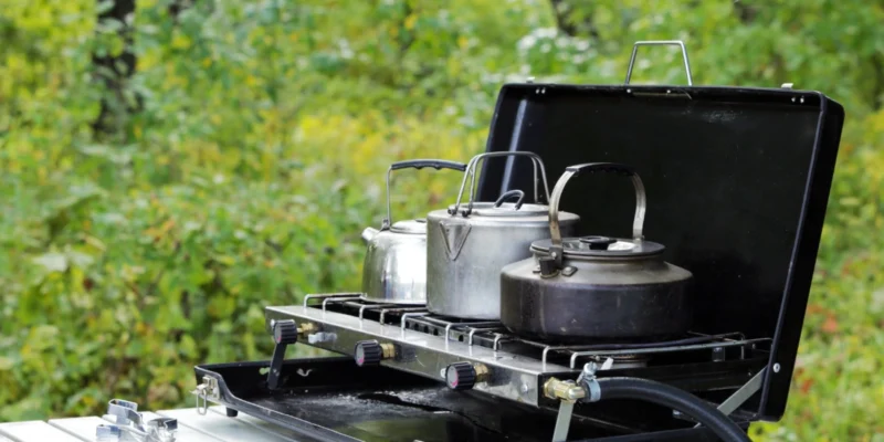 Camp cooking - a propane portable stove with pots and pans